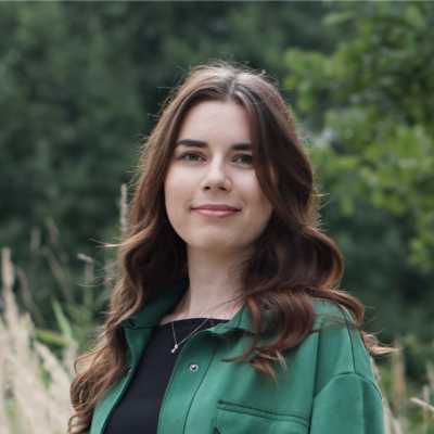 Headshot of Eliška Robenhauptová, Development Engineer, smiling in an outdoor setting.