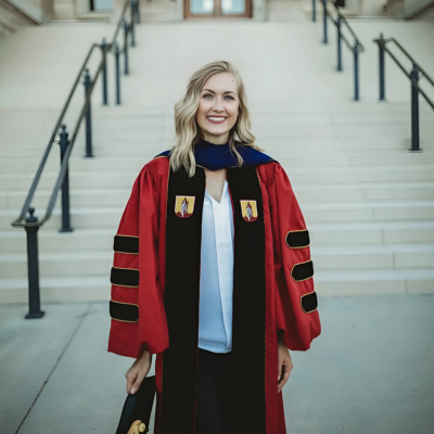 Headshot of Natalie Thompson, Oceanographer and Marine Geologist, smiling and dressed in graduation robes.